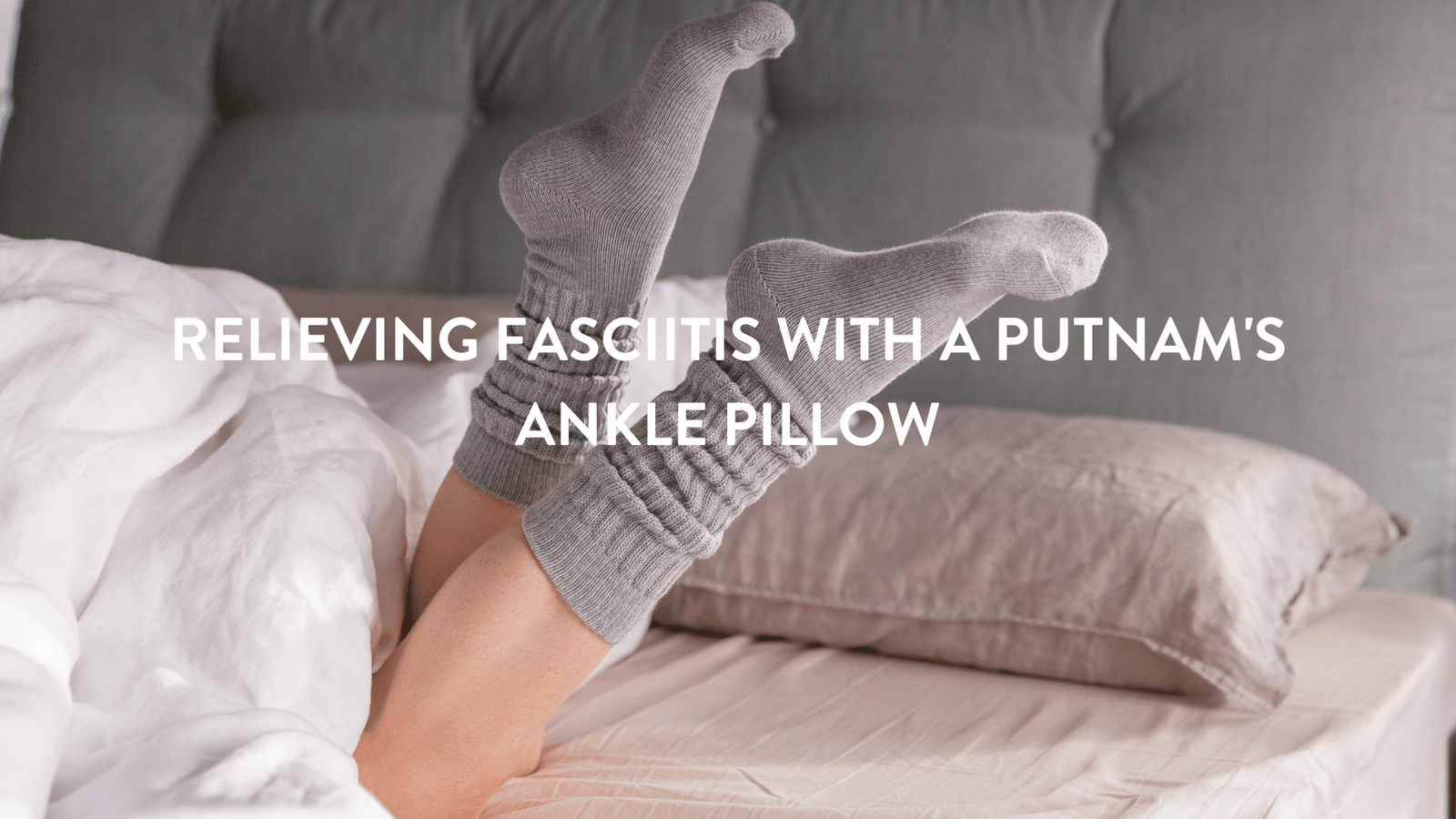 person with grey woolen socks on in bed