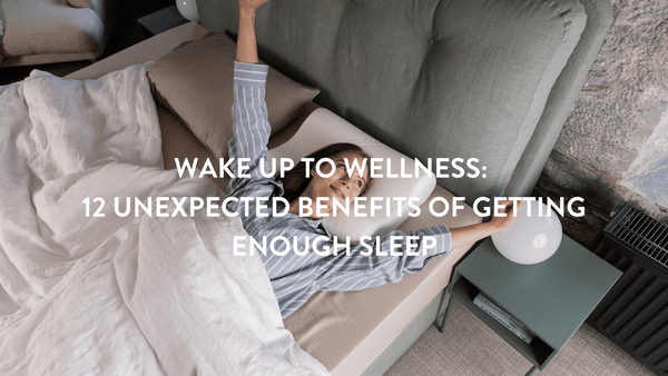 Person in light blue pyjamas waking up in bed with teal headboard in a stone walled cottage