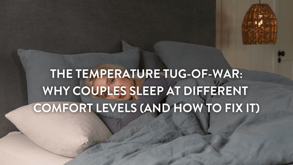 Person lying in bed on a putnams pillow under a grey duvet