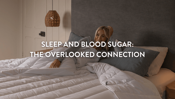 Person sitting up in bed propped up on Putnams pillows in a tranquil bedroom setting