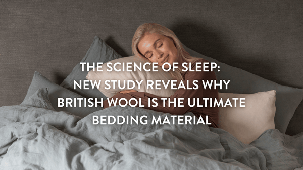 Person sitting up in bed hugging a Putnams British Wool pillow