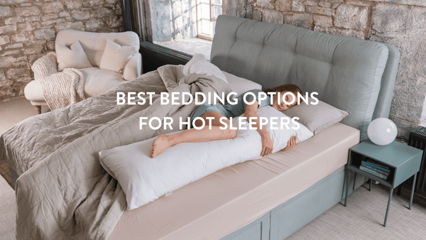 Person sleeping in a bed with a long Putnams body pillow 