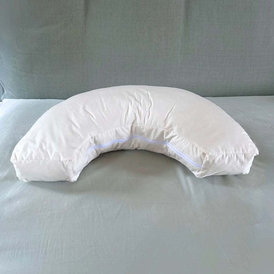 Organic Nursing Pillow - Bottle & Breastfeeding Pillow with unbleached cotton cover and visible zip, placed on a bed